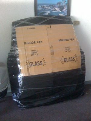 Packing and shrink wrapping top of a car - Packing Service Inc